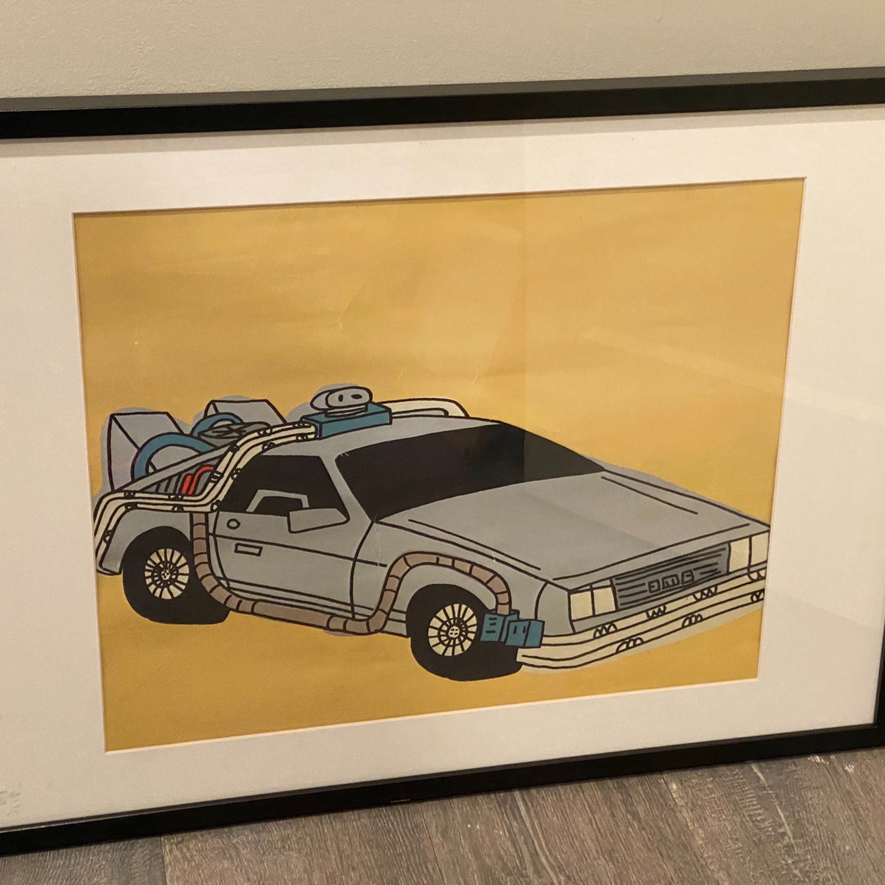 Rare Marz Jr. signed pop art of DMC DeLorean, framed and colorful, showcasing nostalgic design.